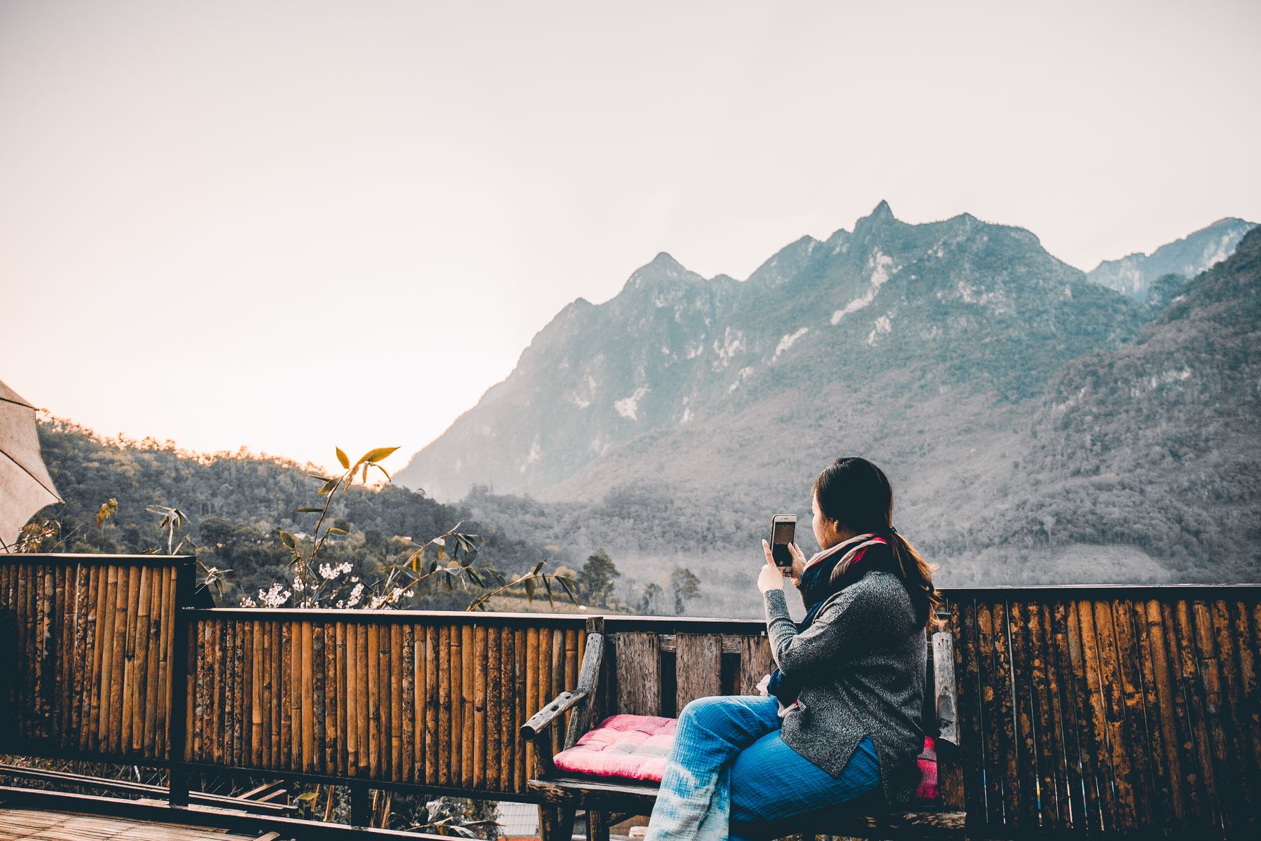Young traveller photographing a mountain view