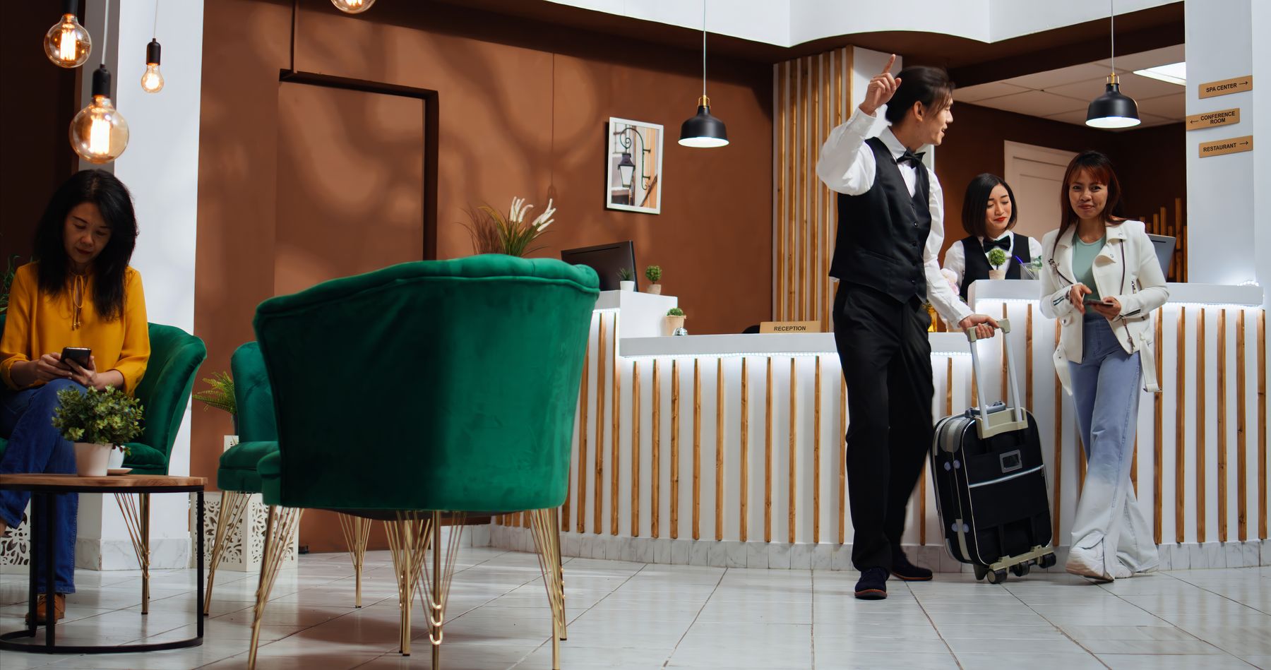Receptionist handing a guest their room key